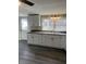 Bright kitchen featuring white cabinets, stainless steel sink, neutral countertop, and vinyl flooring at 354 Bloomingdale Rd, Montezuma, IN 47862