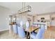 Open dining room leading to the kitchen area featuring modern light fixture and lots of natural light at 3718 Cantebury Dr, Franklin, IN 46131