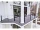 Spacious balcony with modern railings, white pillars, and glass doors leading to the home's interior at 395 Breakwater Dr, Fishers, IN 46037