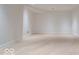 A spacious room boasts light hardwood floors, recessed lighting, and a neutral color scheme at 395 Breakwater Dr, Fishers, IN 46037