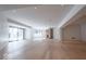 Large living space features light wood floors, recessed lighting, stone fireplace, and large windows at 395 Breakwater Dr, Fishers, IN 46037