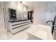 Elegant bathroom with a soaking tub, a spacious double vanity with marble countertops, and a large closet space at 395 Breakwater Dr, Fishers, IN 46037