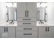 A modern bathroom features a double vanity with white cabinets and black hardware, offering sleek and stylish design at 395 Breakwater Dr, Fishers, IN 46037