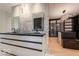 Modern bathroom featuring dual sinks with marble countertops, contemporary lighting, and a large walk-in closet at 395 Breakwater Dr, Fishers, IN 46037