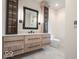 Bathroom vanity with lots of storage, black hardware and a geometric mirror at 395 Breakwater Dr, Fishers, IN 46037