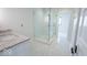 Bright bathroom with a frameless glass shower, stylish vanity, and intricate tile flooring at 395 Breakwater Dr, Fishers, IN 46037
