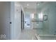 Bright bathroom featuring tiled floors, glass shower, vanity with storage and a view into an adjacent bedroom at 395 Breakwater Dr, Fishers, IN 46037