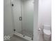 A well-lit bathroom features a glass shower door, hexagon shower tiles, and a modern toilet at 395 Breakwater Dr, Fishers, IN 46037