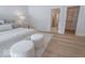 Bright bedroom with comfortable bed, ottomans, and closet access at 395 Breakwater Dr, Fishers, IN 46037