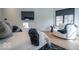 Modern bedroom featuring a large bed with decorative pillows, a chair near the window, and a wall-mounted TV at 395 Breakwater Dr, Fishers, IN 46037