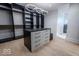 Well-organized walk-in closet with custom shelving and a center island for accessories and storage at 395 Breakwater Dr, Fishers, IN 46037
