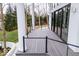 A view of the deck with black railing, white columns, and sliding glass doors at 395 Breakwater Dr, Fishers, IN 46037