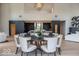 Open-concept space featuring a dining area with modern lighting that flows seamlessly into the kitchen at 395 Breakwater Dr, Fishers, IN 46037