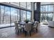 Dining room with wood floors, large windows showcasing the outdoors, and stylish seating at 395 Breakwater Dr, Fishers, IN 46037