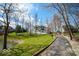 Scenic view of a long driveway leading to a modern home with a lakeside view at 395 Breakwater Dr, Fishers, IN 46037