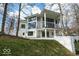 Beautiful modern home with a white exterior, black framed windows, and lush green yard at 395 Breakwater Dr, Fishers, IN 46037