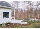 The backyard of this modern home features a balcony, retaining wall, and a serene pond at 395 Breakwater Dr, Fishers, IN 46037