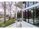 A view of the side of the home showing the deck, many windows, and waterfront view at 395 Breakwater Dr, Fishers, IN 46037