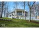 Stunning modern home features large windows, white exterior, and meticulously landscaped grounds at 395 Breakwater Dr, Fishers, IN 46037
