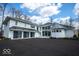 Elegant white home featuring a black metal roof, a three-car garage and an extra turret at 395 Breakwater Dr, Fishers, IN 46037