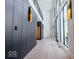 Hallway with modern design, including paneled walls, sconces, and hardwood floors at 395 Breakwater Dr, Fishers, IN 46037