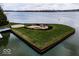 A captivating waterfront island with a charming fire pit and seating area at 395 Breakwater Dr, Fishers, IN 46037