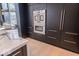 Modern kitchen with stainless steel double oven, dark cabinets with gold hardware, and white marble countertop at 395 Breakwater Dr, Fishers, IN 46037