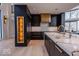 Bright modern kitchen features a large island with marble countertop and dark cabinets with gold hardware at 395 Breakwater Dr, Fishers, IN 46037