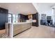 Modern kitchen features large island with marble countertop, and dark cabinets with gold hardware at 395 Breakwater Dr, Fishers, IN 46037