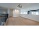 Upstairs landing with modern light fixture and black metal railings at 395 Breakwater Dr, Fishers, IN 46037