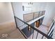 Upstairs landing with black metal railings and hardwood floors at 395 Breakwater Dr, Fishers, IN 46037