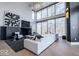 Bright living room with large windows, a comfortable sofa, and stylish decor at 395 Breakwater Dr, Fishers, IN 46037