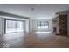 Spacious living room features hardwood floors, stone fireplace, and sliding door to the outdoors at 395 Breakwater Dr, Fishers, IN 46037