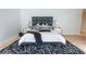 Beautiful main bedroom with modern decor, hardwood floors, and a stylish rug at 395 Breakwater Dr, Fishers, IN 46037