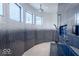 Open concept shower area with dual shower heads and mosaic tile design from ceiling to floors at 395 Breakwater Dr, Fishers, IN 46037