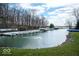 Scenic waterfront view with a dock and fountain feature at 395 Breakwater Dr, Fishers, IN 46037
