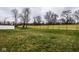 Wide backyard with green grass and a long fence at 401 Thomas Point Dr, Fortville, IN 46040
