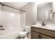 Well-lit bathroom featuring a shower-tub combo, modern vanity, and sleek fixtures at 401 Thomas Point Dr, Fortville, IN 46040