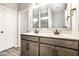 Bathroom featuring a double sink vanity with neutral toned wood and a large mirror at 401 Thomas Point Dr, Fortville, IN 46040