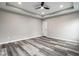 Large bedroom with luxury vinyl plank flooring, a ceiling fan, and recessed lights at 401 Thomas Point Dr, Fortville, IN 46040