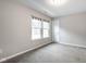 Comfortable bedroom featuring neutral walls, plush gray carpet, and a pair of windows at 401 Thomas Point Dr, Fortville, IN 46040