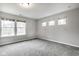 Bright bedroom featuring neutral walls, plush gray carpet, and three large windows allowing ample natural light at 401 Thomas Point Dr, Fortville, IN 46040