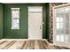 A freshly painted entryway features luxury vinyl plank floors, an exterior door and an interior door at 401 Thomas Point Dr, Fortville, IN 46040