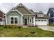 Charming single Gathering home showcasing green siding and a well-manicured front lawn at 401 Thomas Point Dr, Fortville, IN 46040