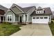 Charming single Gathering home featuring an attached two-car garage and a wide driveway at 401 Thomas Point Dr, Fortville, IN 46040