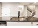 Kitchen island with a stainless steel sink, faucet, and white cabinets below a dark countertop at 401 Thomas Point Dr, Fortville, IN 46040
