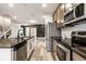 Modern kitchen featuring stainless steel appliances, a large island, and sleek countertops at 401 Thomas Point Dr, Fortville, IN 46040