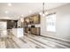 Open concept kitchen featuring stainless steel appliances, shaker cabinets, and an island at 401 Thomas Point Dr, Fortville, IN 46040