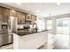 Modern kitchen featuring stainless steel appliances, a kitchen island, and dark countertops at 401 Thomas Point Dr, Fortville, IN 46040