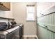 Convenient laundry room with modern washer and dryer units, overhead cabinets, and stylish accents at 401 Thomas Point Dr, Fortville, IN 46040